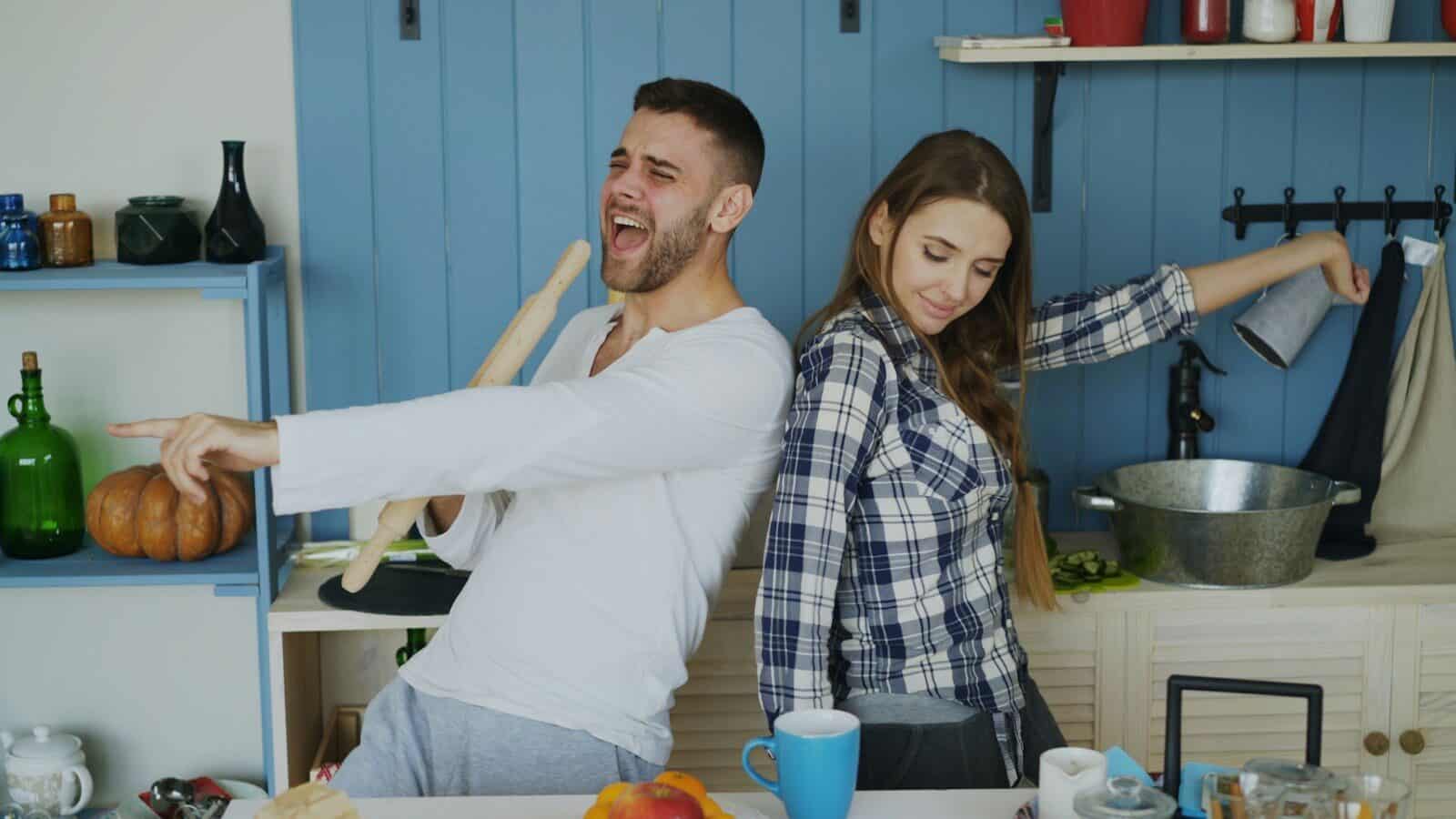 Couple dancing and singing in a kitchen